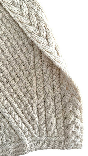 The central chunky cable is exceptionally textured and fully reversible — a signature design detail that ensures a beautifully finished edge from both sides. The sophisticated cable patterns enhance visual depth, interest, durability, and structure.