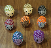 A prickle of the fidget hedgehogs.  Notice the 2 made with Caron Perfect Match (cream color) that are larger than the others.  This yarn is a thicker worsted weight and I had to use a larger hook.