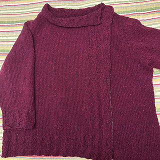 My finished masterpiece blocked, with stabilizing ribbon and snaps in place.