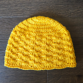 The Little Bit of Sunshine Hat is worked from the top down in one piece with a simple textured stitch pattern.