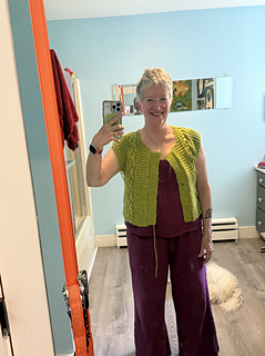 I forgot to take "wearing before blocking" pics...sigh.  This in progress to shows that the sweater as knit is definitely fitted and not 5-6" wearing ease.  Luckily, blocking helped!