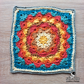 Large textured granny square suitable for blanket projects, displaying raised stitches and a balanced square layout.