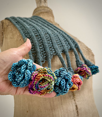 These generic flowers were knit up using mystery fingering yarns from stash! The scarf has 2 dropped stitches between 'stems'.