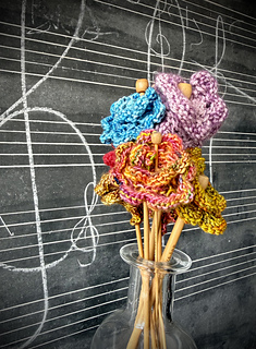Using wooden knitting needles through the centers of the generic flowers, it makes for a lovely bouquet.