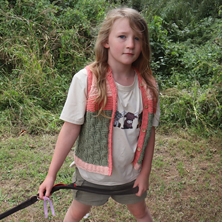8 year old wearing 'age 10' size, in shades of peach and green, in an outdoor countryside setting
