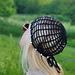 Close-up of the beaded details on a black crochet hat pattern, highlighting the craftsmanship.