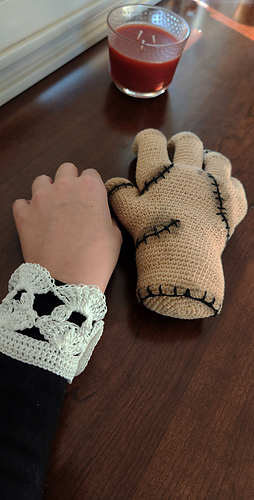 Side-by-side comparison of a real human hand and the finished crocheted hand, highlighting the impact of the "dirty" weathering.