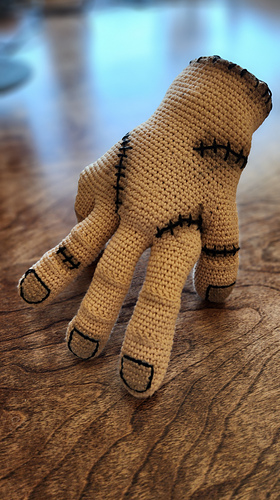 Finished Wednesday hand prop on a shelf, showcasing its use as spooky, Gothic home decor.