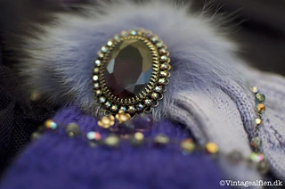 The gloves styled with a vintage brooch, a necklace and earrings