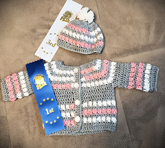 Received a first place ribbon in the crocheted baby sweater class at the 2025 Chilliwack Fair. The hat received a 3rd in the crocheted toque class.