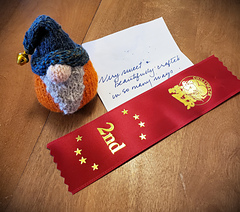 The gnome chosen to represent the group received a 2nd place ribbon at the 2025 Chilliwack Fair in the handspun-handknit small article class.