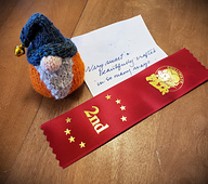 The gnome chosen to represent the group received a 2nd place ribbon at the 2025 Chilliwack Fair in the handspun-handknit small article class.