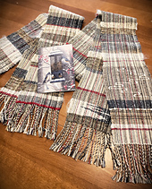 Two scarves from the same warp along with the Christmas card that inspired the colourway.