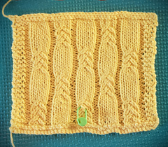 Gauge swatch, washed, dried to damp in dryer, and blocked. Meeting gauge requirements.