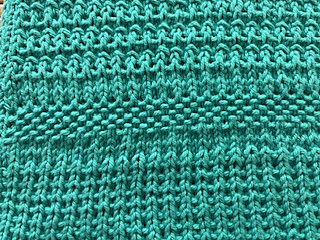 A solid color yarn highlights the textures