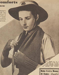 HERE you see a member of the Services wearing mittens and scarf specially designed for warmth and comfort.