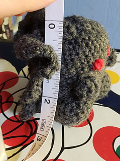 Mothman next to a tape measure