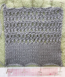 This is the swatch after blocking. As you can see, the bottom curls; if I were making this I'd add a small hem on the wrong side to counteract the curl.