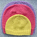 newborn yellow hat on top of red child hat on top of lilac adult hat