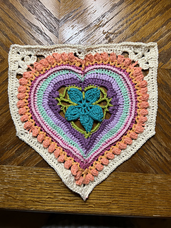 Heart House motif gauge swatch done (unblocked).