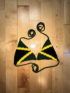 Jamaica flag bikini top lies on a wooden surface