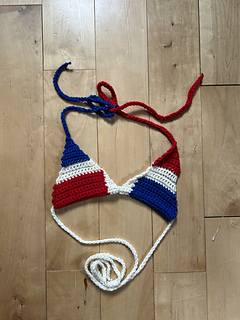 Flag bikini lies flat on a wooden surface