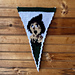 Crochet pennant flag features image of the scarecrow