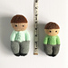 Doll on the left is knit in worsted weight on 3.25mm; doll on the right is knit in DK on 2.75mm