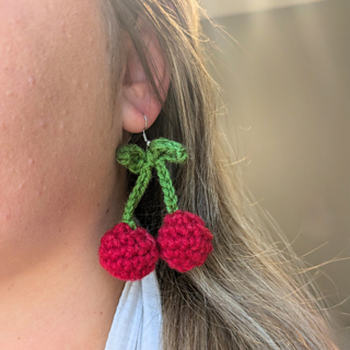 crochet earrings are shown as worn.