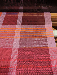 the end of the red-stripes-on-red towel and the start of the orange-stripes-on-pink towel