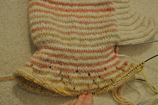 ripped this out and did a 2x2 ribbing instead, no increases. Worked out fine.