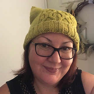 A somewhat chuffed knitter in an adorable hat. 