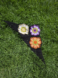 Black lace headscarf with bright floral granny squares laid flat