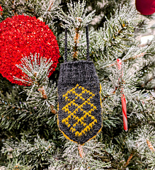 Sesqui Holiday ornament, O, hanging on a tree at Target.