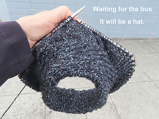 Knitting while waiting for the bus.