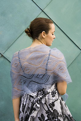 A flowing, openwork lace rectangular stole with gradient shading