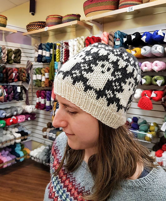 Cream and charcoal hat with a ring of stranded colorwork ghosts