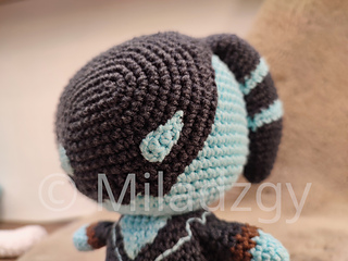 Thresh from League of Legends, crochet toy made by amigurumi technique.  Used dark grey, turqoise and brown yarn. Face detail view.