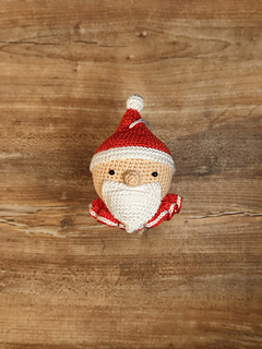 Santa Claus, Christmas crochet bauble. Festive decoration to hang on the Christmas tree. Red and white cap, collar, white beard.