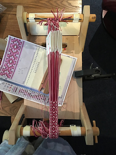 Weaving setup.  Note the clamp holding the loom down.