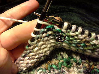 Grab the back bump of the stitch below and knit into it.