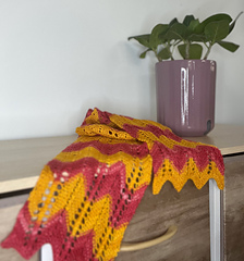 scarf on dresser with plant in background