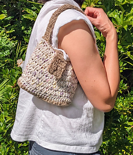 Crochet cotton mini baguette shoulder bag with raffia base and flap 