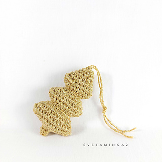 A crocheted minimalist Christmas tree featuring fancy yarn as the result of a detailed pattern for christmas amigurumi toy.