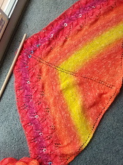 On row 125, with lifeline at Row 107, just before frogging back. That magenta stripe has GOT to go...it's even worse IRL than it looks here!