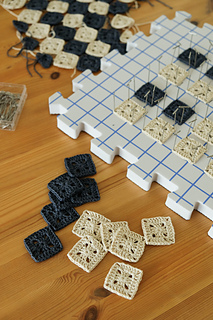 I recommend alternating between crocheting squares, weaving ends in and blocking.