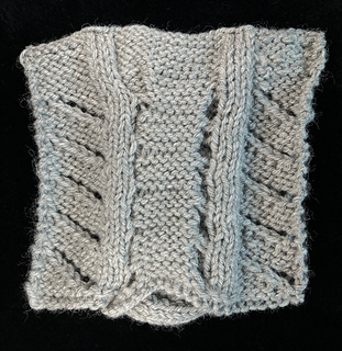 Wrong side: note that without a deep border, the bottom cast-on edge is distorted by the cable.