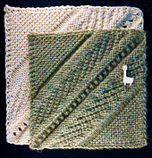 Identical blocks but the 6" green one is sport yarn weight and the 7.5" ecru block is worsted weight yarn.