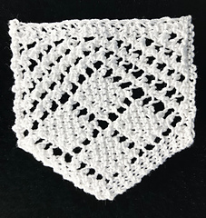 A single repeat of 4 of Diamonds blocked: it could look cute as a background for a brooch or as a bunting with several strung together.