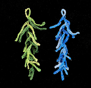 Knit from the bottom up. Loop is 10 chain stitches with steel crochet hook.